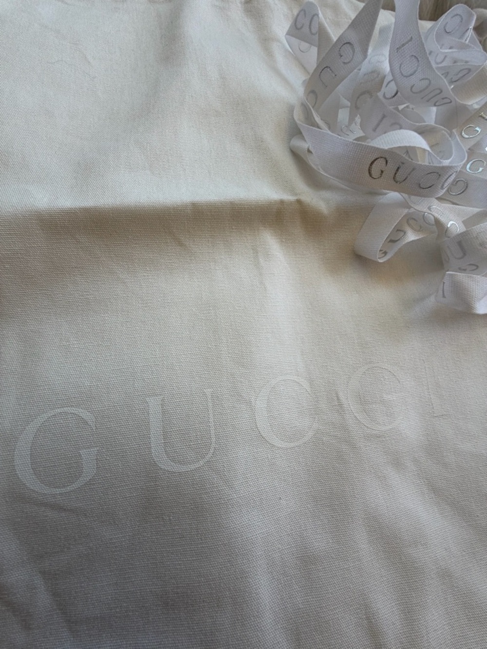 Gucci cream logo dust bag with branded white ribbon